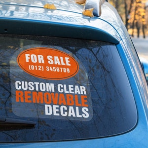 May include: A blue car with a sticker on the back window that says "For Sale (012) 3456789" and "Custom Clear Removable Decals".