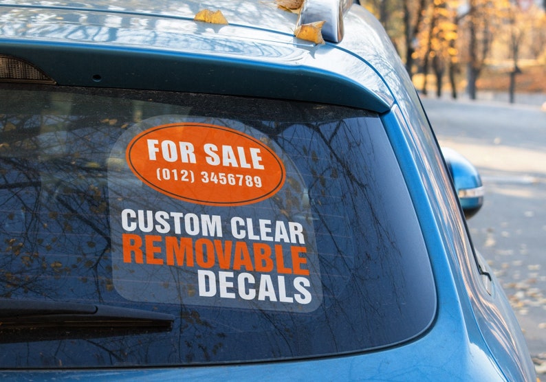 May include: A blue car with a sticker on the back window that says "For Sale (012) 3456789" and "Custom Clear Removable Decals".