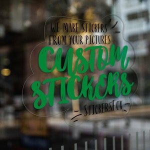 May include: A green and black custom sticker design on a clear glass surface. The sticker says "We make stickers from your pictures Custom Stickers - StickersFox - "
