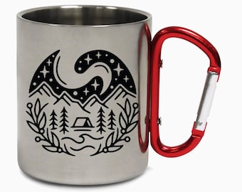 May include: A stainless steel camping mug with a red carabiner handle. The mug features a black graphic of a mountain scene with a tent, trees, and stars. The mug is designed for outdoor use.