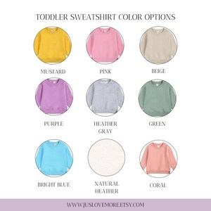 May include: A graphic displaying nine toddler sweatshirts in various colors: mustard, pink, beige, purple, heather gray, green, bright blue, natural heather, and coral. The text "TODDLER SWEATSHIRT COLOR OPTIONS" is at the top. The website address is at the bottom.