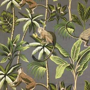 May include: A gray fabric with a repeating pattern of monkeys and palm trees. The monkeys are brown and have long tails. The palm trees are green and have large leaves.