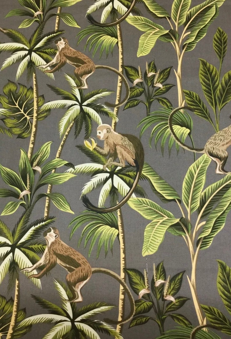 May include: A gray fabric with a repeating pattern of monkeys and palm trees. The monkeys are brown and have long tails. The palm trees are green and have large leaves.