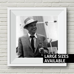 May include: Black and white photo of a man wearing a hat and suit, smiling and holding a cigarette. The text "LARGE SIZES AVAILABLE" is at the bottom of the image.