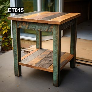 May include: A reclaimed wood side table with a rectangular top and a lower shelf. The tabletop is a mix of brown, orange, and grey tones. The legs and shelf are painted teal. The table's dimensions are approximately 60 cm x 60 cm x 60 cm. The text "ET015" is in the top left corner.
