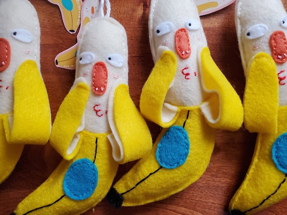 A handmade felt banana with a full blush — peak absurdist charm with 597 favorites proving this silly little guy has a genuine cult following.