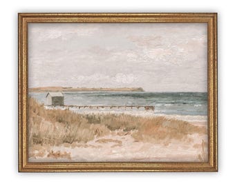 May include: A framed landscape painting depicting a coastal scene with a small white structure on a wooden pier extending into the sea. The foreground features sandy dunes with tall grasses, while the background shows a distant shoreline under a cloudy sky.
