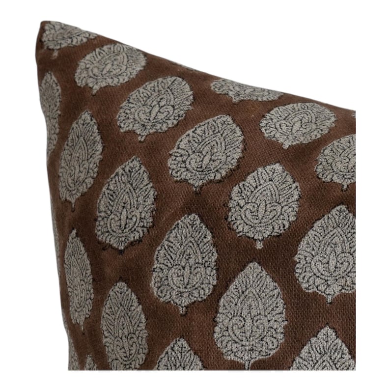 May include: A brown pillow with a white and black leaf pattern.