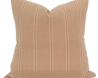 May include: A beige and brown striped throw pillow with a square shape.