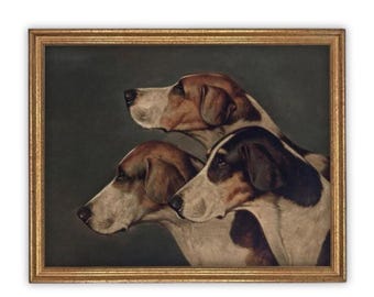 May include: A framed painting depicting three hound dogs in profile against a dark background. The dogs have white, brown, and black coats. The artwork is enclosed in a textured gold-colored frame, capturing the heads of the three animals.