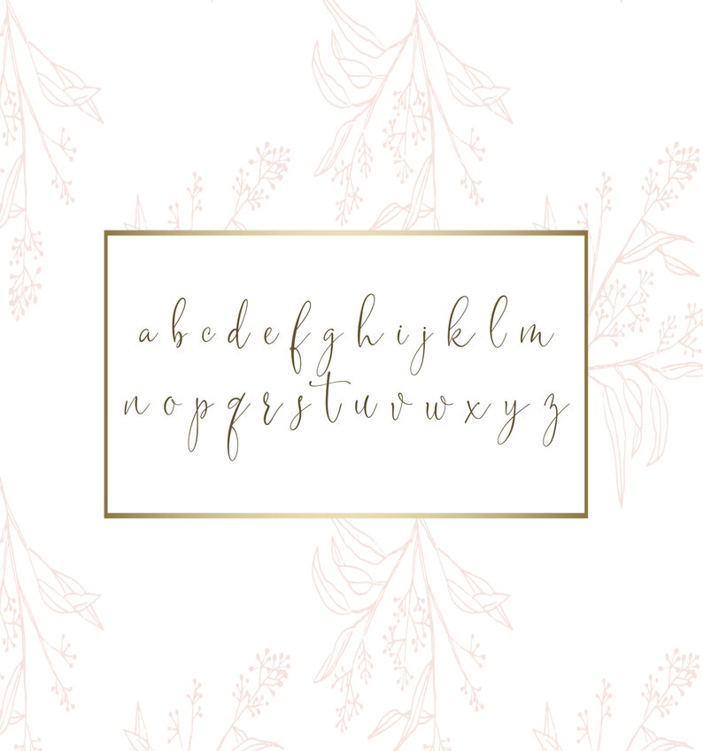 May include: A gold-colored, handwritten lowercase alphabet is displayed inside a gold rectangular frame. The letters are in a cursive style. The background is white with a pattern of pink floral line drawings.