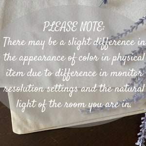 May include: A close-up of a white fabric with the text "PLEASE NOTE: There may be a slight difference in the appearance of color in physical item due to difference in monitor resolution settings and the natural light of the room you are in."  The fabric is folded over and a sprig of lavender is in the background.