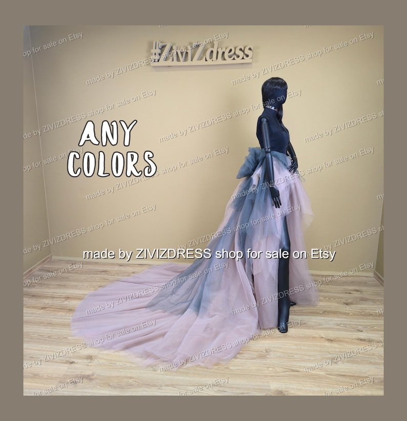 May include: A black mannequin showcases a layered tulle skirt with a long train. The skirt fades from pink to grey-blue. The text "ANY COLORS" is visible, along with the shop's name.