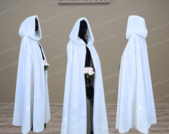 May include: A white hooded cape with a long flowing design. The cape is made of a soft, plush fabric and has a simple, elegant style.