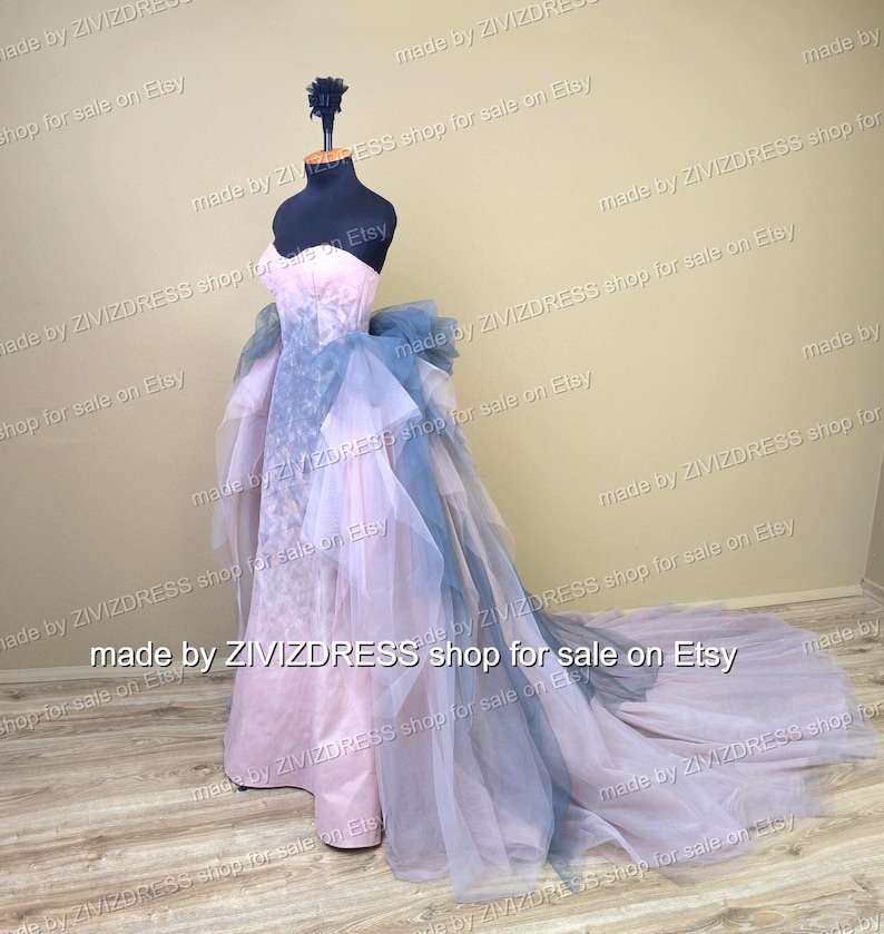 May include: A strapless, floor-length gown on a mannequin. The dress features a pale pink bodice and a flowing skirt with layers of blue and lavender tulle. The train extends behind the mannequin. The text "made by ZIVIZDRESS shop for sale on Etsy" is visible.