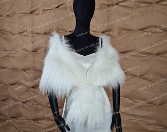 May include: A white faux fur shawl with a fluffy texture. The shawl is draped over a white dress form.