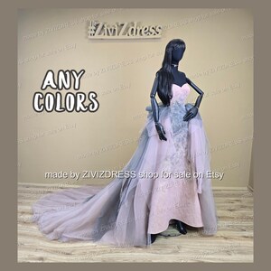 May include: A formal gown on a mannequin, featuring a strapless bodice and a flowing skirt with a long train. The dress is primarily pink with gray and tulle accents. The text "ANY COLORS" is displayed on the left.