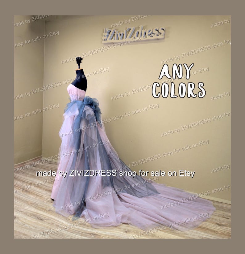 May include: A strapless formal gown in pink, blue, and gray, displayed on a mannequin. The dress features a long, flowing train and a layered design. The text "ANY COLORS" is visible.