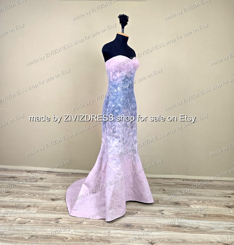 May include: A strapless, floor-length gown on a black mannequin. The dress features a gradient design, transitioning from a light pink bodice to a blue and purple patterned midsection, and back to pink at the flared hem. The text "made by ZIVIZDRESS shop for sale on Etsy" is visible.