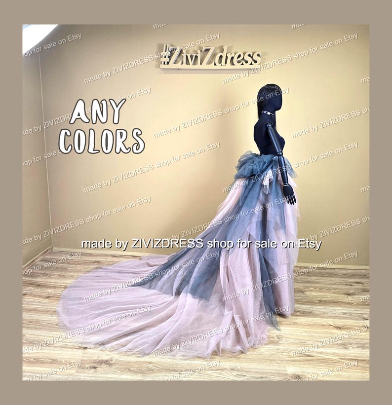 May include: A layered tulle skirt with a long train is displayed on a mannequin. The skirt features dusty rose, grey-blue, and darker blue accents. The text "ANY COLORS" is visible. The skirt is suitable for special occasions.