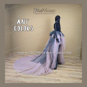 May include: A black mannequin wearing a layered tulle skirt with a long train. The skirt features layers of pink, grey, and black tulle. The text "ANY COLORS" is displayed in white.
