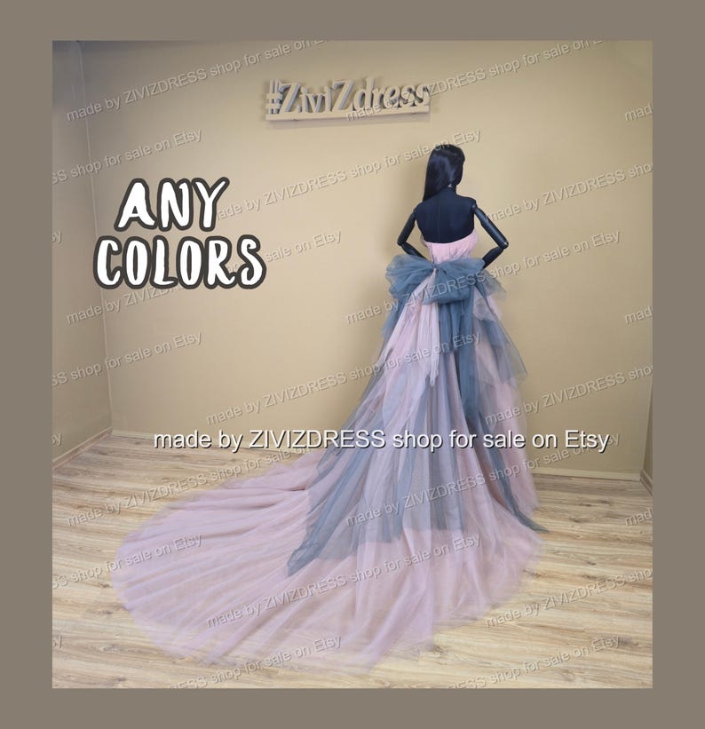 May include: A formal gown in shades of pink and blue, displayed on a mannequin. The dress features a layered skirt and a large bow at the back. The text "ANY COLORS" is visible.