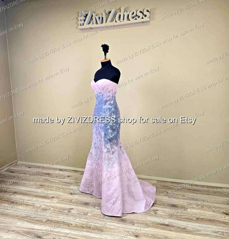 May include: A strapless, floor-length gown on a mannequin. The bodice is a light pink, transitioning to a blue and pink patterned skirt. The dress has a mermaid silhouette and a long train. The background includes the text "#Ziv7dress" and "made by ZIVIZDRESS shop for sale on Etsy."