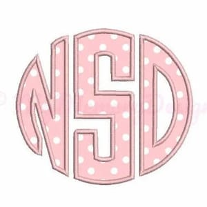 May include: A pink and white polka dot monogram with the letters "NSD" in a circle.