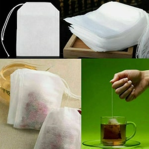 May include: White tea bags with a drawstring. The tea bags are shown being filled with loose leaf tea and being used to brew tea in a cup.