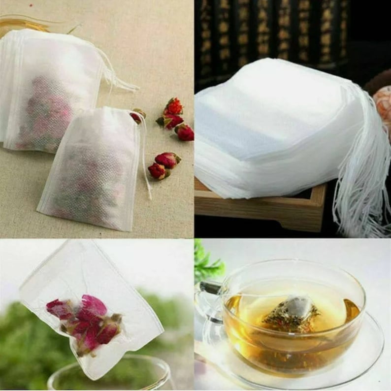 May include: White tea bags made of fine mesh fabric, with a drawstring closure. The bags are shown filled with loose tea leaves and flowers, and are also shown in a stack of many bags. A cup of tea is shown with a tea bag in it.