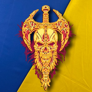 May include: A yellow and red skull with a sword through its head, surrounded by a red and yellow design. The skull has a long, braided beard.