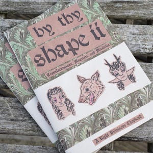 May include: A green and brown marbled cover with the title "By Thy Shape It" in black lettering. The subtitle is "Transformations, Monsters, and Mirabilia". The cover also features illustrations of a wolf, a person with antlers, and a person with a crown.