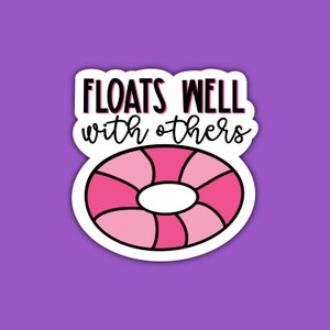 May include: A white sticker with a pink and black inflatable ring and the text "Floats well with others".