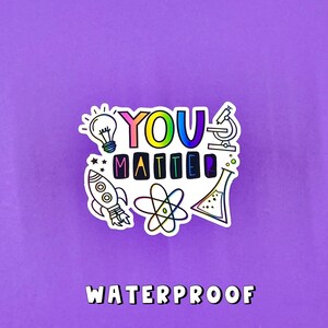 May include: A white sticker with the text "YOU MATTER" in rainbow colors. The sticker is surrounded by colorful illustrations of a lightbulb, a rocket, an atom, a microscope, and a beaker. The text "WATERPROOF" is printed below the sticker.
