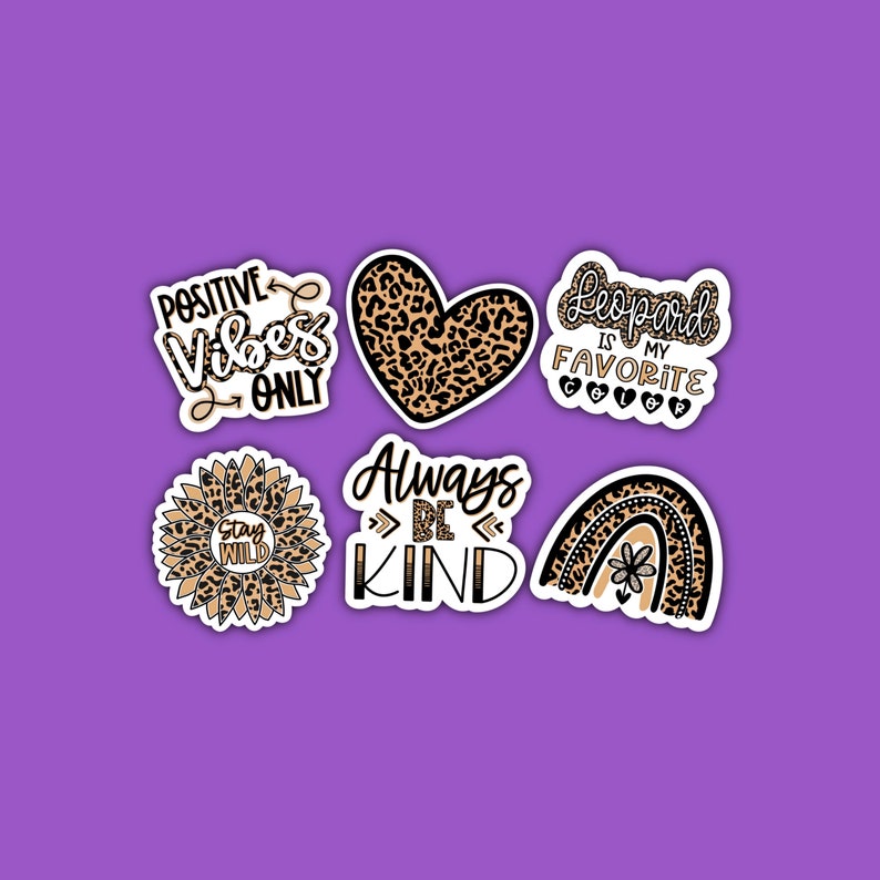 May include: Set of six leopard print stickers with various phrases, including "Positive Vibes Only", "Stay Wild", "Always Be Kind", "Leopard is my Favorite", and a heart and rainbow design.