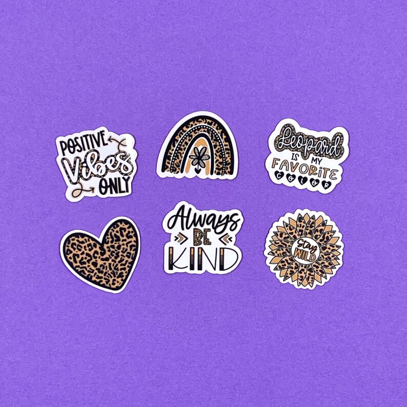 May include: Six leopard print stickers with different sayings. The stickers include "Positive Vibes Only", "Leopard is my Favorite Color", "Always Be Kind", "Stay Wild", and a rainbow with a flower.