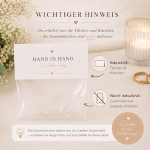 May include: A clear plastic bag with a white paper header card featuring the text HAND IN HAND. Ein Leben lang. The card indicates that the bags and cards are included, while gummy bears are not included and must be purchased separately.