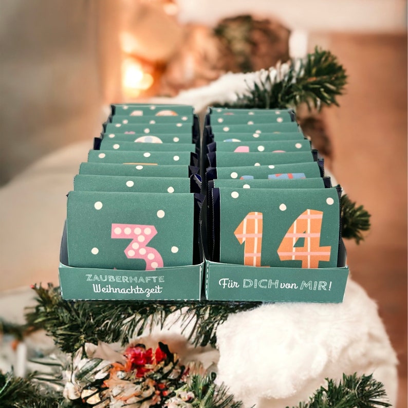 May include: A green and white advent calendar with the numbers 3 and 14 visible. The calendar has the text "Zauberhafte Weihnachtszeit" and "F&uuml;r Dich von Mir!" printed on it.