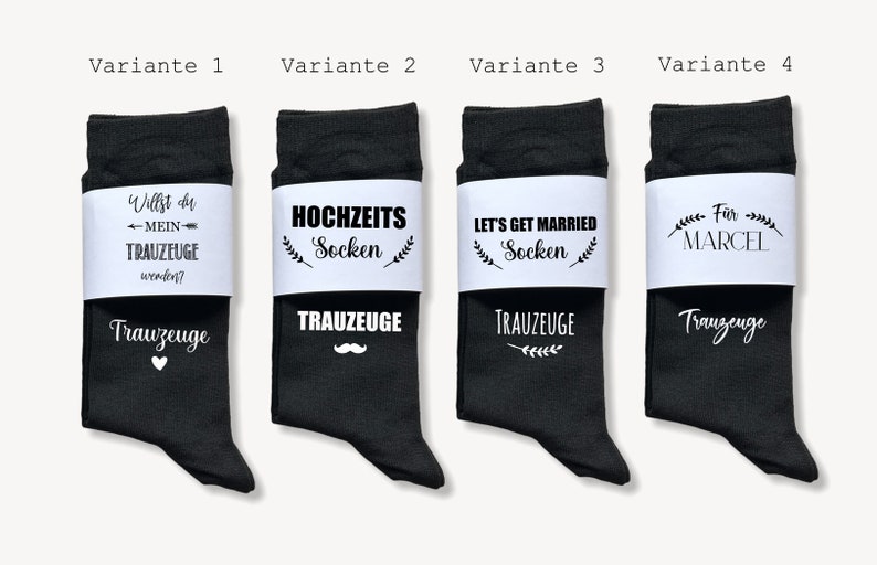May include: Four pairs of black socks with white bands. The socks have various phrases, including "Will you be my groomsman?" and "Let's get married." One pair is personalised with "For Marcel."