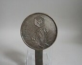 Japanese Antique 18th century, Edo period bronze Kagami mirror. Decorated with a mon crest and flowers with foliage.