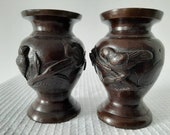 Antique, Japanese Meiji period pair of bronze vases decorated in high relief with birds and flowers Circa 1890-1910.
