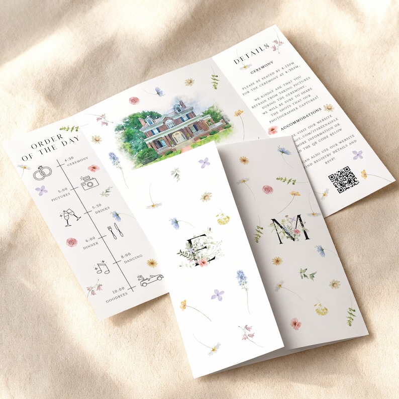 May include: Wedding stationery set featuring a trifold invitation with floral accents and a watercolor illustration of a house. The invitation includes the order of the day, details, and a QR code.
