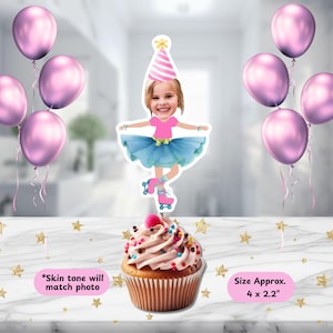 May include: A cupcake with pink frosting and colorful sprinkles, topped with a decorative cutout of a girl in a party hat and roller skates. The image includes pink balloons and text that reads "Skin tone will match photo" and "Size Approx. 4 x 2.2".