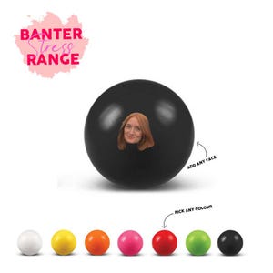 May include: A black stress ball with a face cutout, featuring a woman's face. The text "Banter Stress Range" is in a pink bubble. Below are color options: white, yellow, orange, pink, red, green, and black. Arrows indicate "Add Any Face" and "Pick Any Color."
