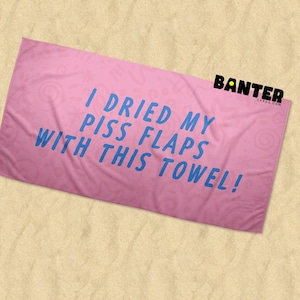 May include: Pink beach towel with the text "I DRIED MY PISS FLAPS WITH THIS TOWEL!" in blue. The towel has a pattern and the word "BANTER" in black.