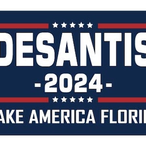 May include: A blue and red political campaign sign with white text that reads "DESANTIS -2024- MAKE AMERICA FLORIDA".