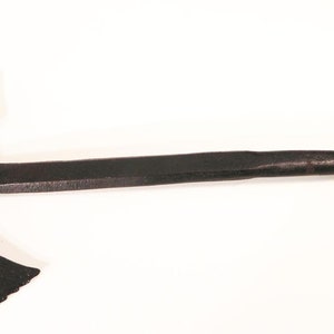 May include: A black metal axe with a curved blade and a wooden handle. The axe is a traditional weapon used for hunting and warfare.