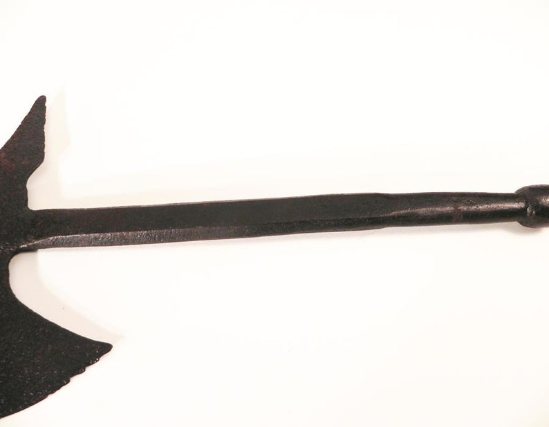 May include: A black metal axe with a curved blade and a wooden handle. The axe is a traditional weapon used for hunting and warfare.
