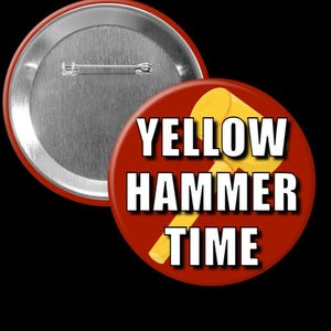 May include: A red button with the text "YELLOW HAMMER TIME" in white letters and a yellow hammer graphic. The button has a silver pin back and a shiny metal rim.