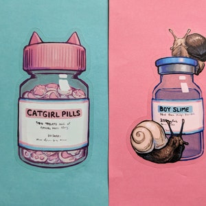 May include: Two illustrated stickers. One shows a pink-lidded bottle labeled "CATGIRL PILLS" filled with paw-shaped pills. The other shows a bottle labeled "BOY SLIME" with snails. The background is split between teal and pink.